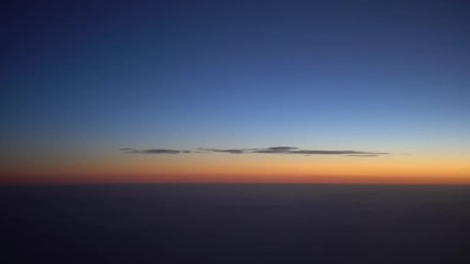 Wall Mural - 4K Traveling by air. Beautiful view of the sky and clouds with the sun from above, as seen through an airplane window in dawn sun-Dan