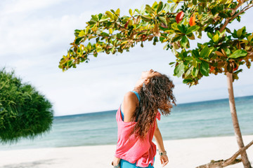 Wall Mural - boho styled young woman walking on the beach