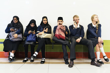 Wall Mural - Group of diverse students using mobile phones