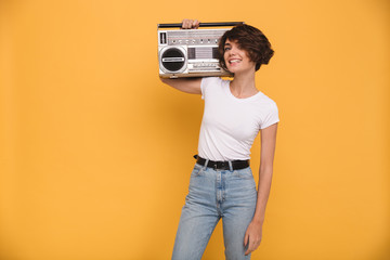 Wall Mural - Portrait of a smiling young girl holding record player