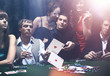 © ASDF - Poker players sitting around a table at a casino