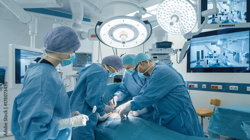 Medical Team Performing Surgical Operation in Bright Modern Operating Room - obrazy, fototapety, plakaty 
