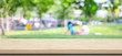 © mangpor2004 - Empty wooden table over blurred people and tree park nature with bokeh background, for product display montage, banner
