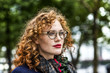 © Westend61 - Portrait of redheaded young woman with red lips wearing glasses
