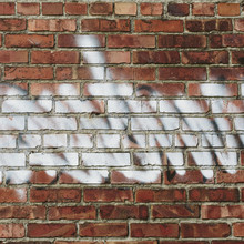 Graffiti On Brick Building Wall