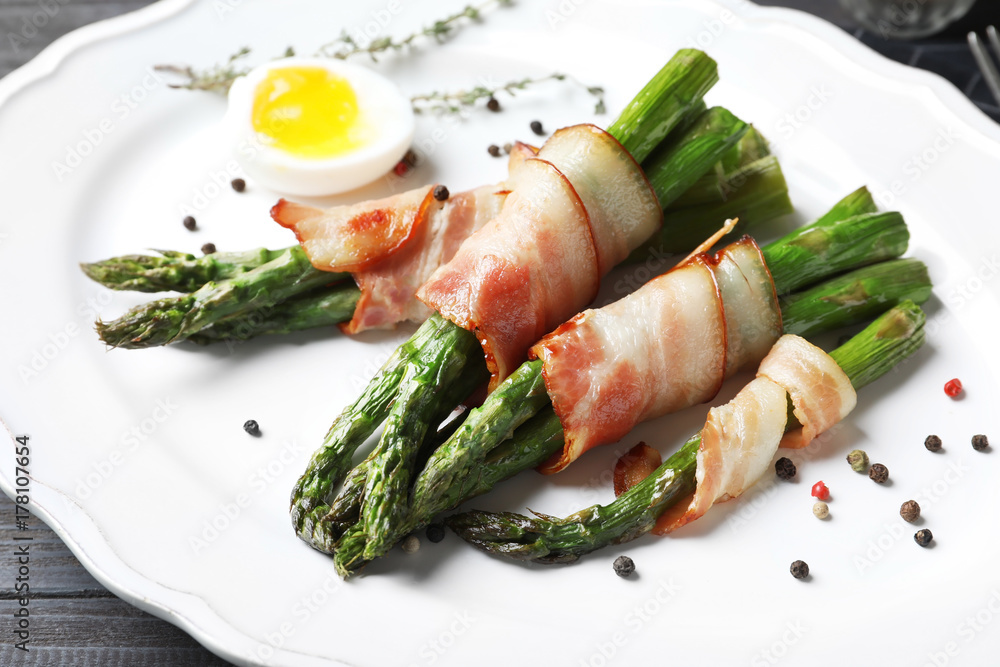 Plate with bacon wrapped asparagus, closeup