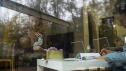 Young family inside the home through the window