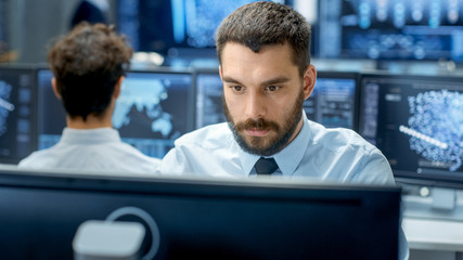 Aufkleber - Neural Network and Machine Learning Engineer Programming at His Workstation. Office is Crowded With People Working. Multiple Displays Show Neural Network, Artificial Intelligence Representation.