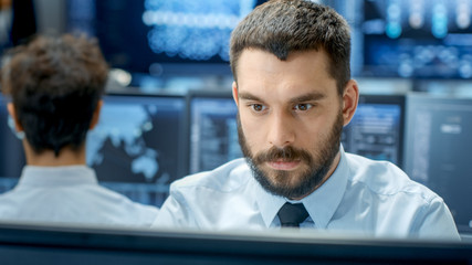 Wall Mural - neural network and machine learning engineer programming at his workstation. office is crowded with 