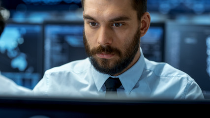 Wall Mural - neural network and machine learning engineer working hard at his workstation. multiple displays show