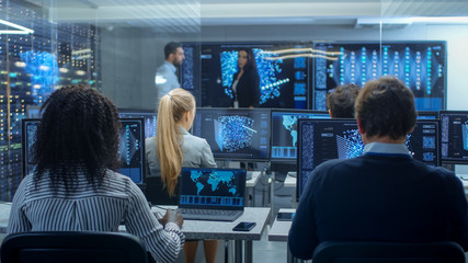 Fototapete - Multi-Ethnic Team of Research Engineers, Neural Network Architects, Programmists Working on a Machine Learning, Neural Network Building Project. Office Displays Show Working Model of Neural Network.