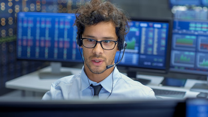 Poster - Broker Making Sales with a Headset with His Multi-Ethnic Team of Stock Traders at the Stock Exchange Firm Office is Busy Selling and Buying Bonds and Shares. Displays Show Relevant Graphs and Numbers.