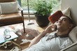 © Wavebreak Media - Man talking on mobile phone in the living room