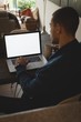 © Wavebreak Media - Man using laptop at home