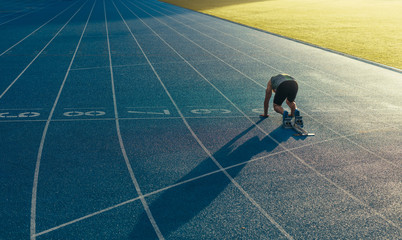 Wall Mural - sprinter on his marks on a running track