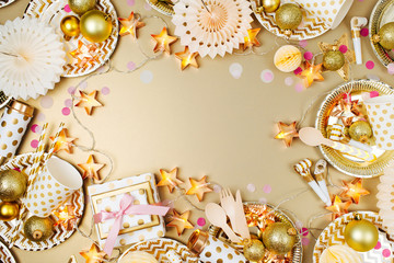 Sticker - Christmas table setting. Frame made of golden  party decoration stuff. Flat lay, top view