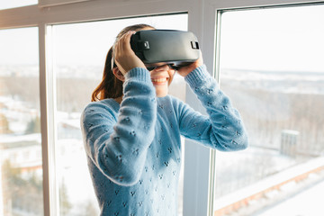 A person in virtual glasses flies to pixels. The woman with glasses of virtual reality. Future technology concept. Modern imaging technology. Fragmented by pixels.