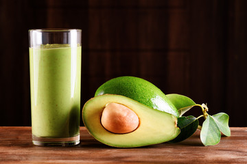 Canvas Print - Fresh avocado smoothie and ripe avocado on wooden table