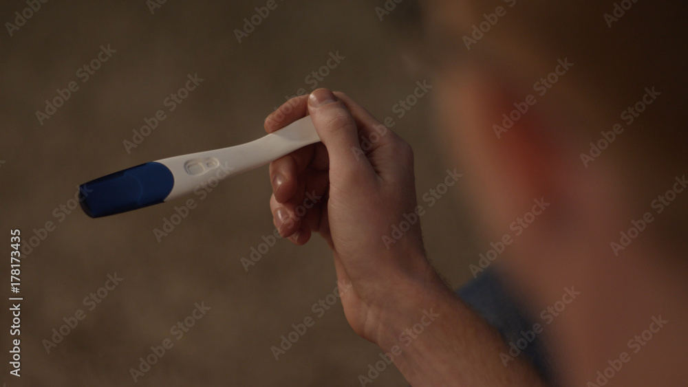 Photo Stock Man Looks At A Pregnancy Test Side View Positive Pregnancy photo-stock-man-looks-at-a-pregnancy-test-side-view-positive-pregnancy