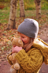  Girl hugging a toy Teddy bear