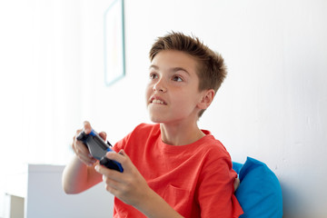 Sticker - happy boy with gamepad playing video game at home