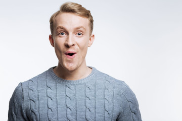 Fair-haired young man looking surprised