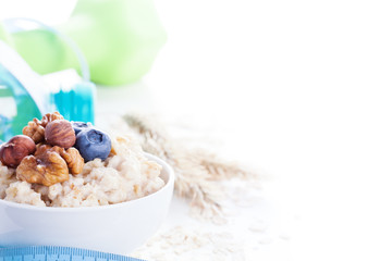 Wall Mural - Delicious oatmeal porridge with berries and nuts