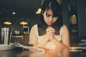 Wall Mural - woman praying in morning. Hands folded in prayer