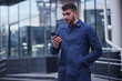 © amixstudio - Businessman looking at phone in social network