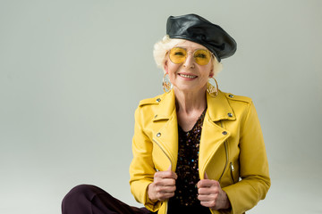 Wall Mural - senior woman in yellow jacket and beret