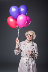 Wall Mural - senior lady holding balloons