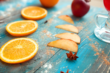 Wall Mural - Orange, apple, cinnamon, anise, wine (mulled wine) on wooden background