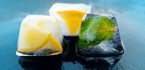 Wall Mural - parts of lemonade - pieces of ice with lemon, mint, orange