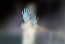 Soft Shutter Haunted Of Ghost Hands Behind The Frosted Glass Negative Film Style, Halloween Concept.