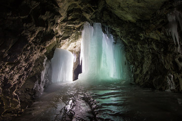 Underground mine shaft tunnel gallery witn ice frozen stalactites stalagmites
