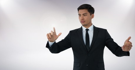 Canvas Print - Businessman touching air with hand gestures in front of white