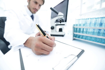 Wall Mural - scientist makes a note of experiment in the laboratory