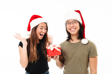 Wall Mural - Portrait of a satisfied asian man in christmas hat