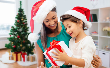 Canvas Print - happy mother and daughter with christmas gift