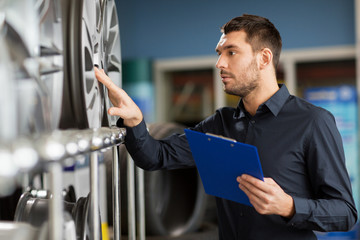 Canvas Print - auto business owner and wheel rims at car service