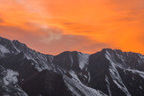 Fototapeta Natura - orange sunset over the mountain peaks