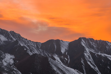 orange sunset over the mountain peaks