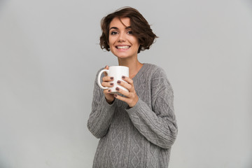 Wall Mural - Happy young lady drinking tea.