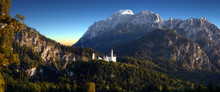 Panoramic View Of The Neuschwanstein Castle With Mountains, Allgaeu Alps, Bavaria, Germany