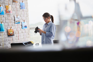 Wall Mural - Photographer Working In Studio With Dslr Camera And Computer