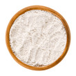 Whole wheat flour in wooden bowl. Whole-wheat flour, also wholemeal flour. White powdery substance and basic food ingredient, used in baking. Isolated macro food photo close up from above over white.
