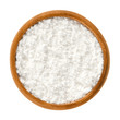 Powdered sugar in wooden bowl. Unsifted finely ground white refined sugar. Also called confectioners or icing sugar and icing cake. Isolated macro food photo close up from above on white background.