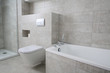 Furnished bathroom with white furniture, tiles in grey