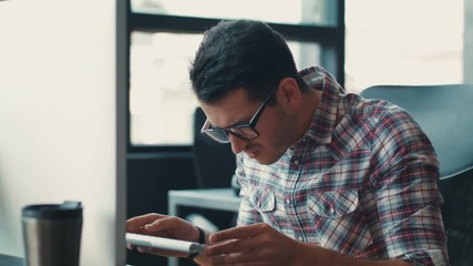 Handsome man in the glasses typing on the keyboard in office use computer corporate developer education engineer business programmer technology worker thinking and trying to resolve a issue problem