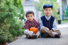 Asian Boys Holding A Pumpkin